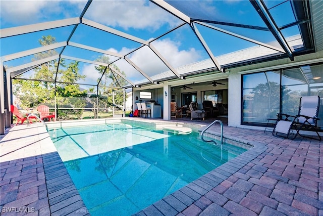 view of pool with ceiling fan, a patio, and glass enclosure