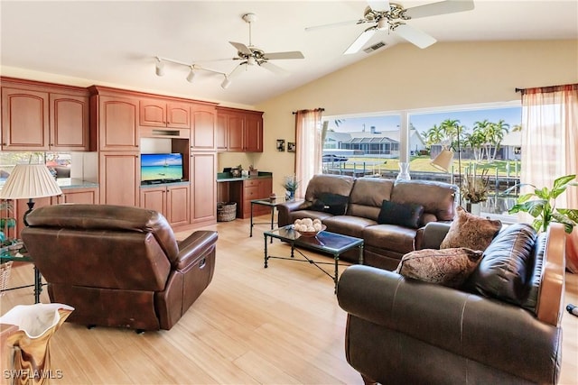 living room featuring light hardwood / wood-style floors, ceiling fan, and lofted ceiling