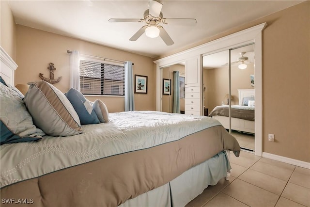 bedroom featuring ceiling fan, light tile patterned floors, and a closet