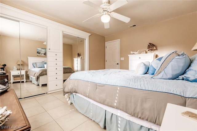 tiled bedroom featuring ceiling fan