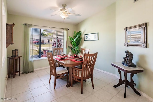 tiled dining space featuring ceiling fan