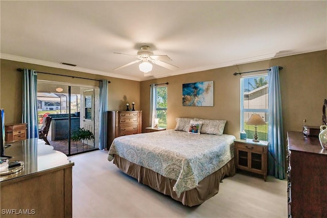 carpeted bedroom featuring ceiling fan, crown molding, and access to outside