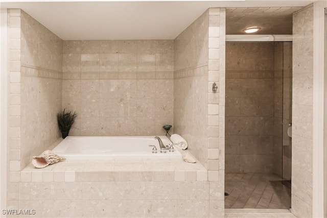 bathroom featuring shower with separate bathtub