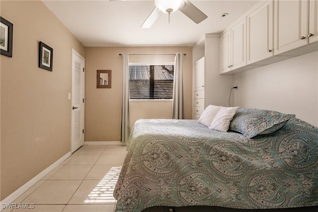 tiled bedroom featuring ceiling fan