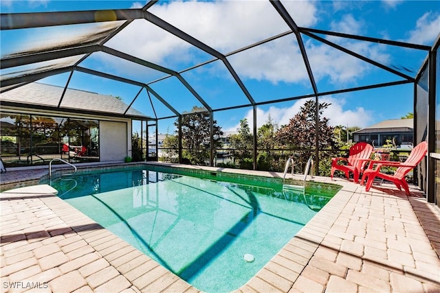 view of swimming pool with glass enclosure and a patio