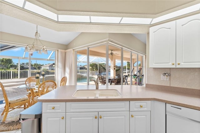 kitchen featuring an inviting chandelier, decorative light fixtures, white cabinetry, and sink