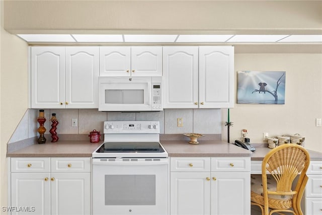 kitchen with white cabinets, white appliances, and tasteful backsplash