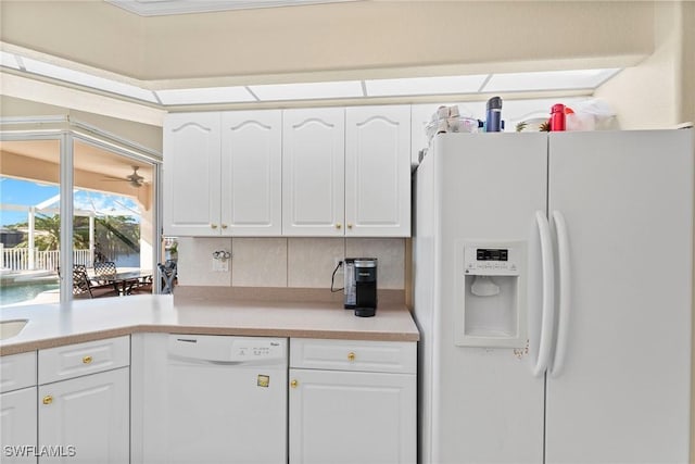 kitchen with decorative backsplash, white cabinets, white appliances, and ornamental molding