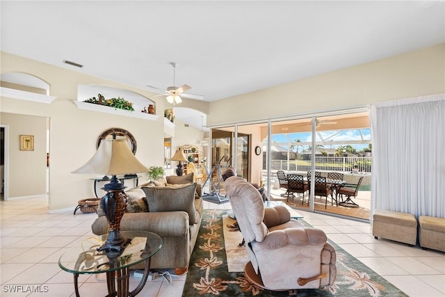 tiled living room featuring ceiling fan