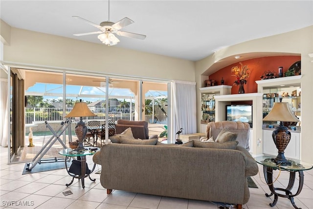 living room featuring ceiling fan, light tile patterned floors, and a healthy amount of sunlight