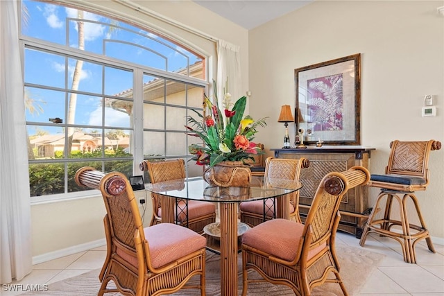 dining area featuring light tile patterned floors and plenty of natural light