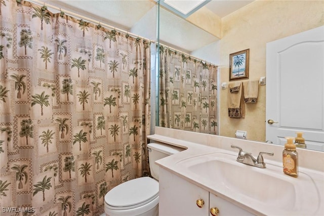 bathroom featuring vanity, toilet, and curtained shower