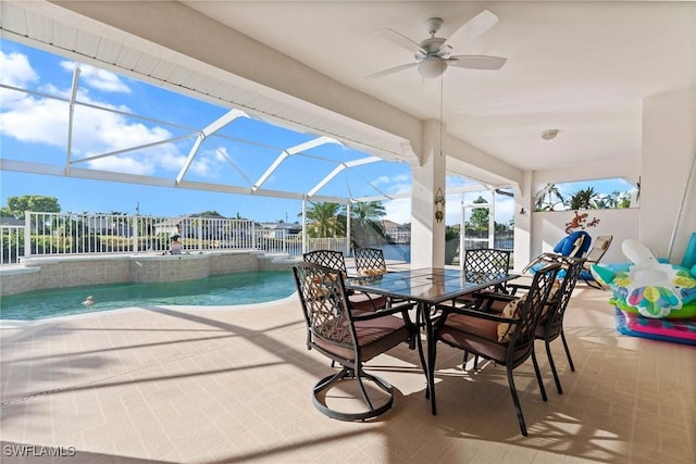 view of patio / terrace with ceiling fan and a lanai