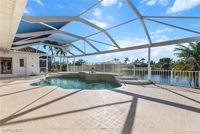 view of swimming pool with a patio, a water view, and glass enclosure