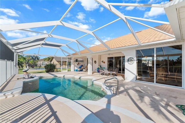 view of swimming pool with a patio area, ceiling fan, and glass enclosure