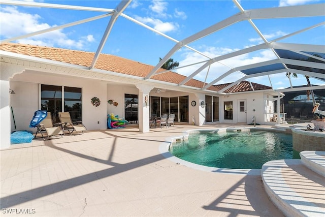 view of swimming pool featuring glass enclosure, ceiling fan, and a patio