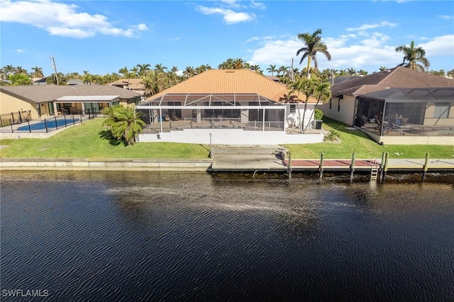 rear view of property with a lanai and a water view