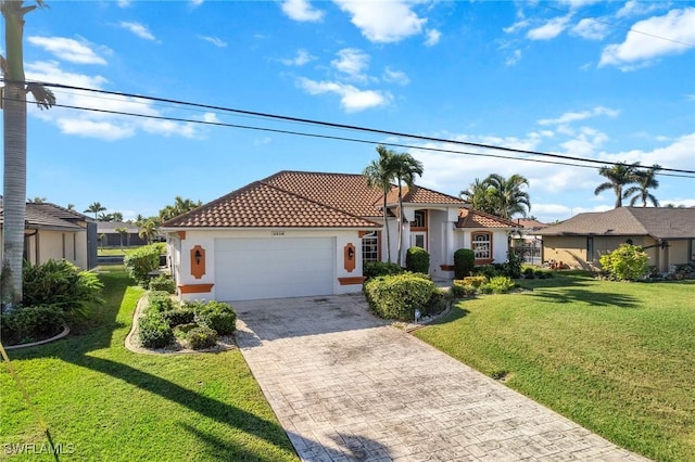 mediterranean / spanish-style home with a garage and a front lawn