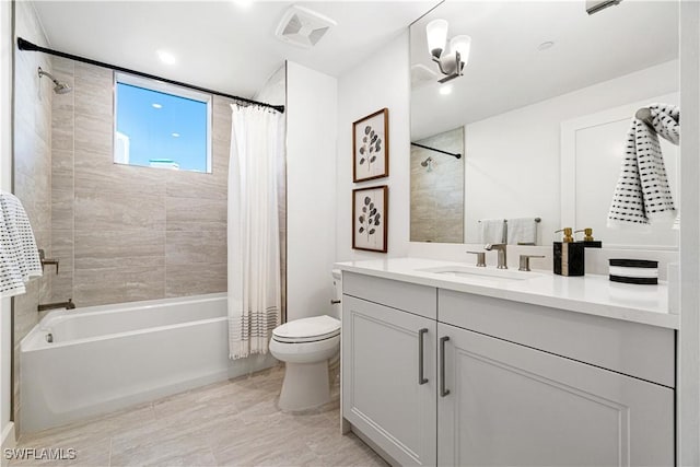 full bathroom with shower / bath combo with shower curtain, vanity, and toilet