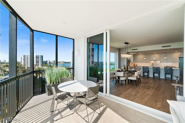 sunroom with a water view and a healthy amount of sunlight