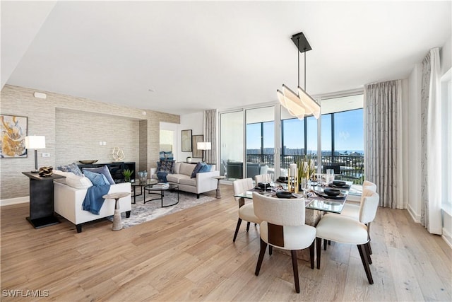 dining area with light hardwood / wood-style flooring and floor to ceiling windows