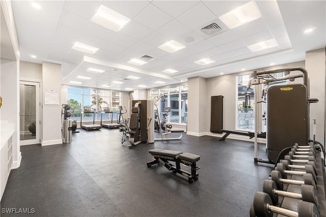 gym with a paneled ceiling