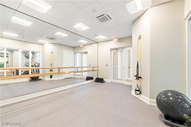 workout area with a paneled ceiling