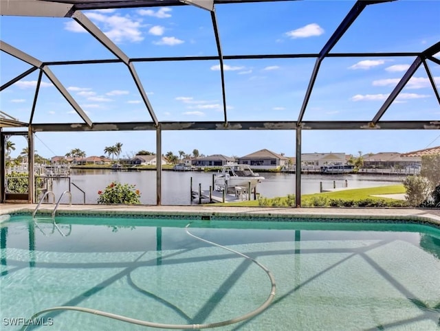 view of pool featuring a lanai, a water view, and a boat dock