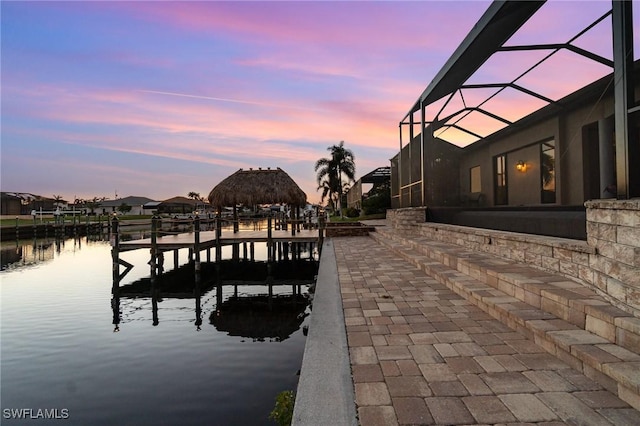 dock area with glass enclosure and a water view