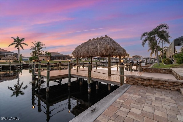 view of dock with a gazebo and a water view