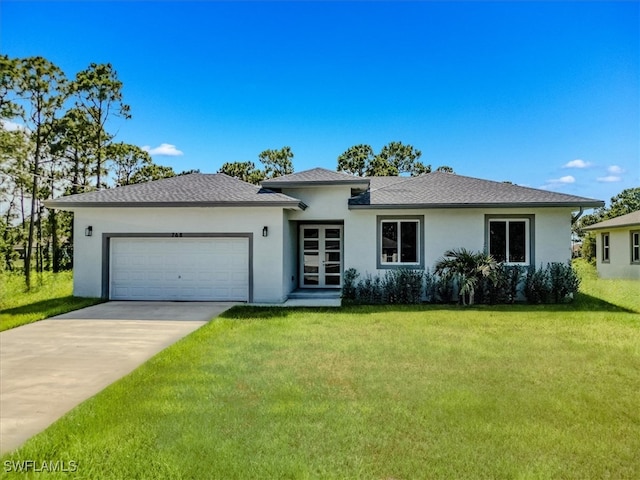 view of front of home featuring a front yard and a garage