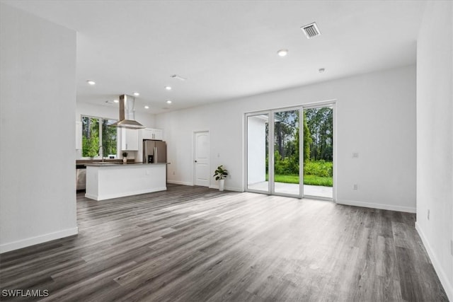 unfurnished living room with sink and dark hardwood / wood-style floors