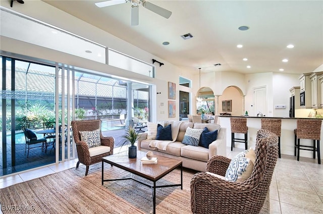 living room featuring ceiling fan, a healthy amount of sunlight, and light tile patterned flooring