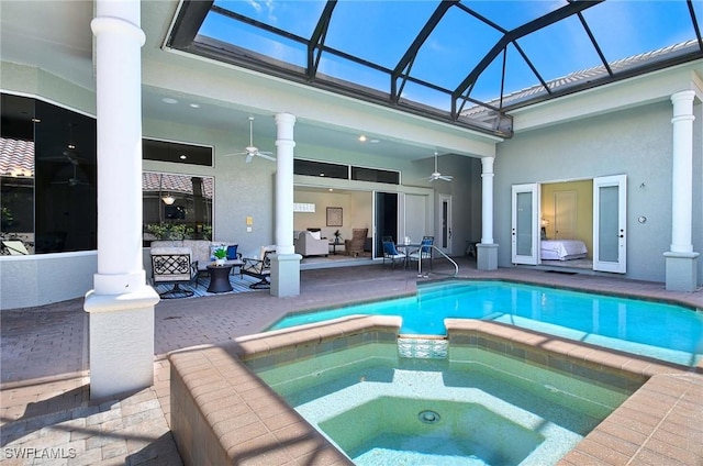 view of swimming pool featuring an in ground hot tub, outdoor lounge area, ceiling fan, glass enclosure, and a patio area