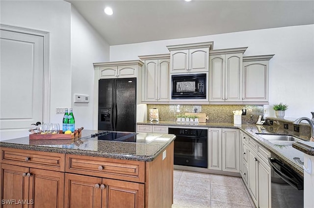 kitchen featuring black appliances, sink, decorative backsplash, dark stone countertops, and light tile patterned flooring