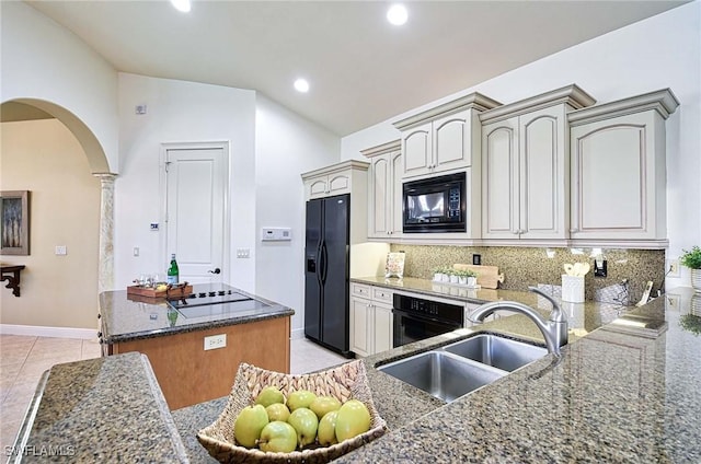 kitchen with sink, decorative columns, backsplash, lofted ceiling, and black appliances