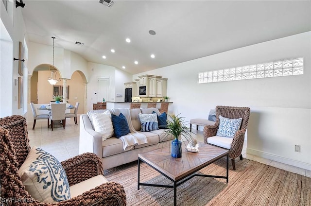 tiled living room featuring vaulted ceiling