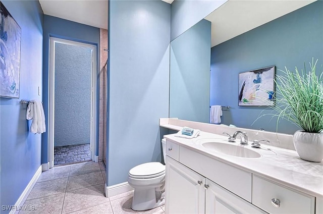 bathroom with tile patterned floors, walk in shower, vanity, and toilet