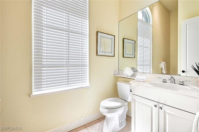 bathroom featuring tile patterned flooring, vanity, and toilet