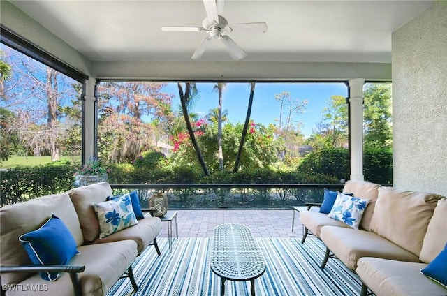 sunroom / solarium featuring ceiling fan