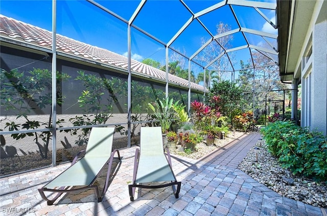 view of patio with glass enclosure