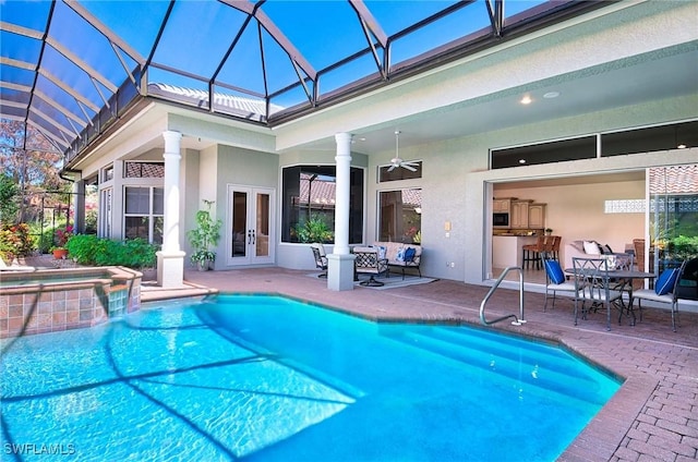 view of pool featuring ceiling fan, a lanai, an in ground hot tub, and a patio