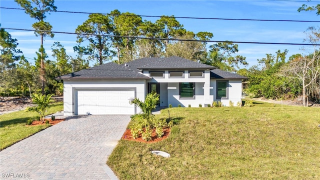 view of front of property with a front lawn and a garage