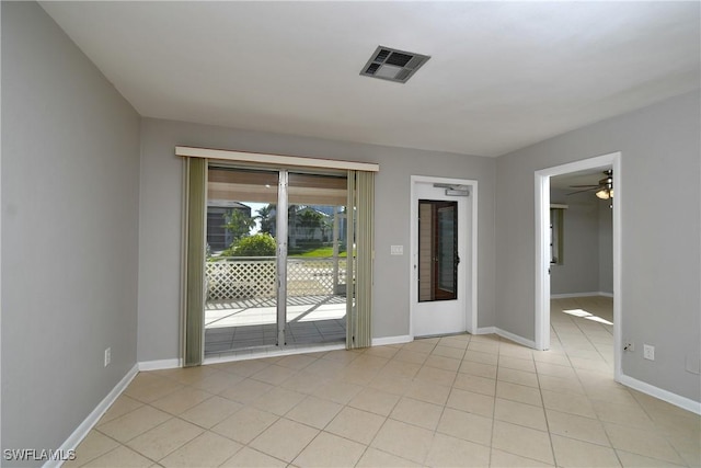 unfurnished room with light tile patterned floors and ceiling fan