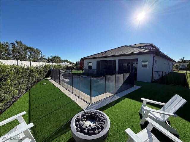 view of pool with a lawn