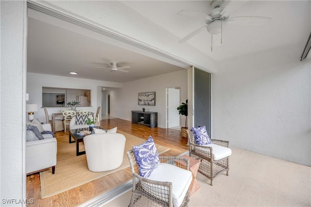 living room featuring wood-type flooring and ceiling fan