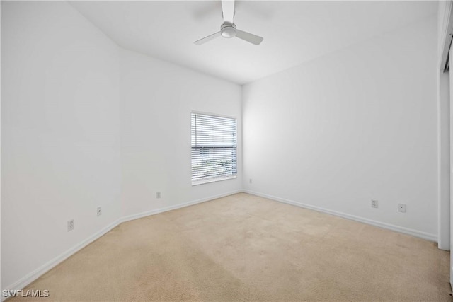 unfurnished room featuring ceiling fan and light carpet