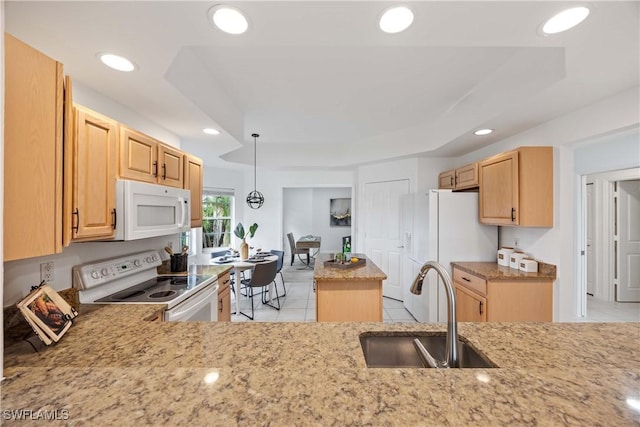 kitchen featuring pendant lighting, white appliances, a raised ceiling, and sink