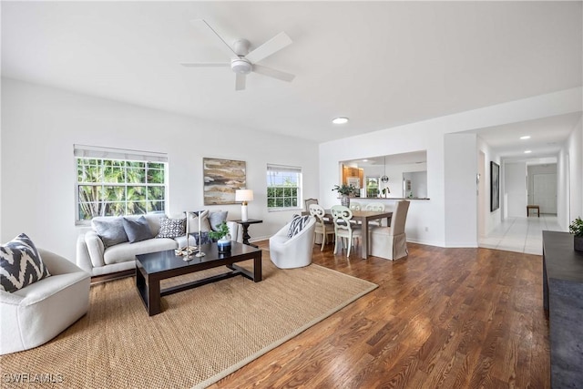 living room with hardwood / wood-style floors and ceiling fan