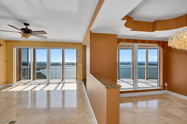 empty room with crown molding, a water view, and ceiling fan with notable chandelier